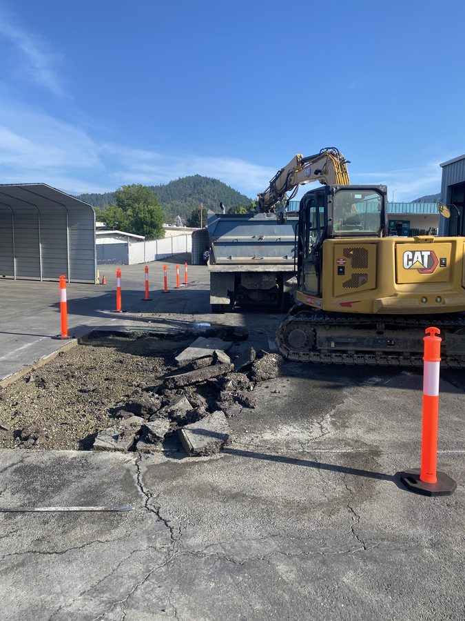 Damaged asphalt demolished and excavated to base at Caveman Towing in preparation for new pavement, Grants Pass, Oregon