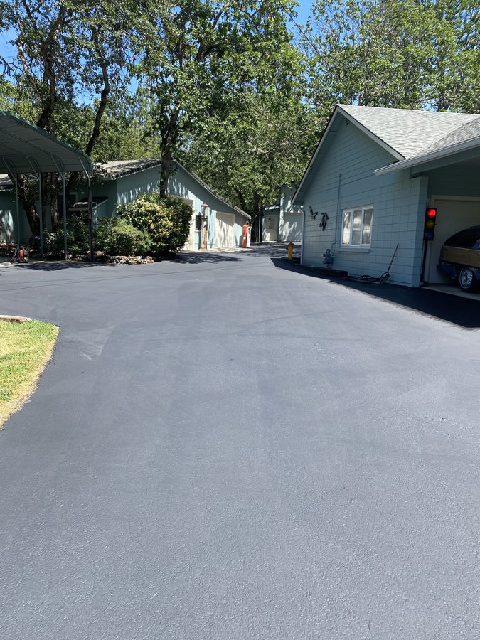 Driveway sealcoated to a smooth, uniform dark finish on Soldier Creek Road in Grants Pass, Oregon